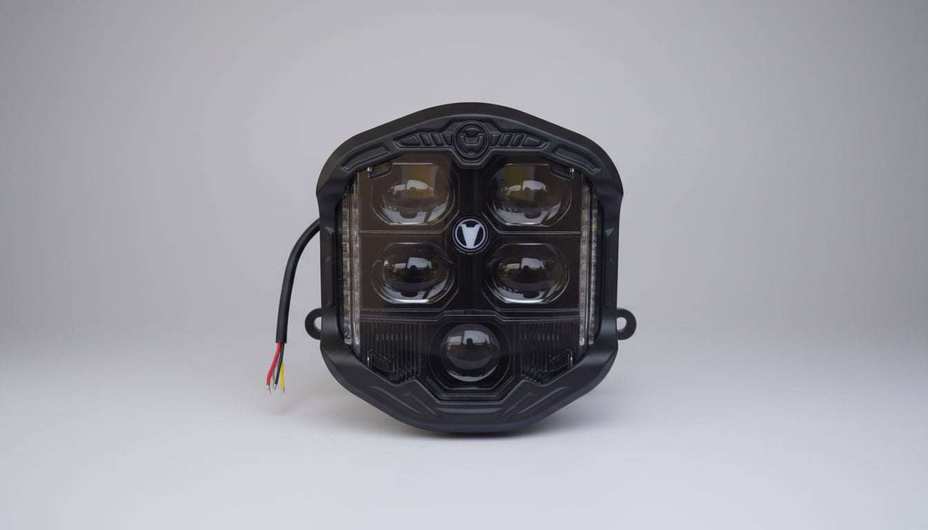 Black LED light module on a white background with a cardboard box in the background