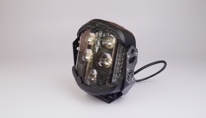 LED light bulb on a white surface with a brown cardboard box in the background