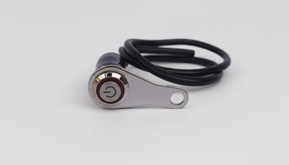 Metal lever switch with a cable on a light gray background