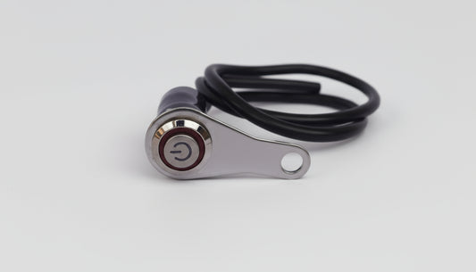 Metal lever switch with a cable on a light gray background